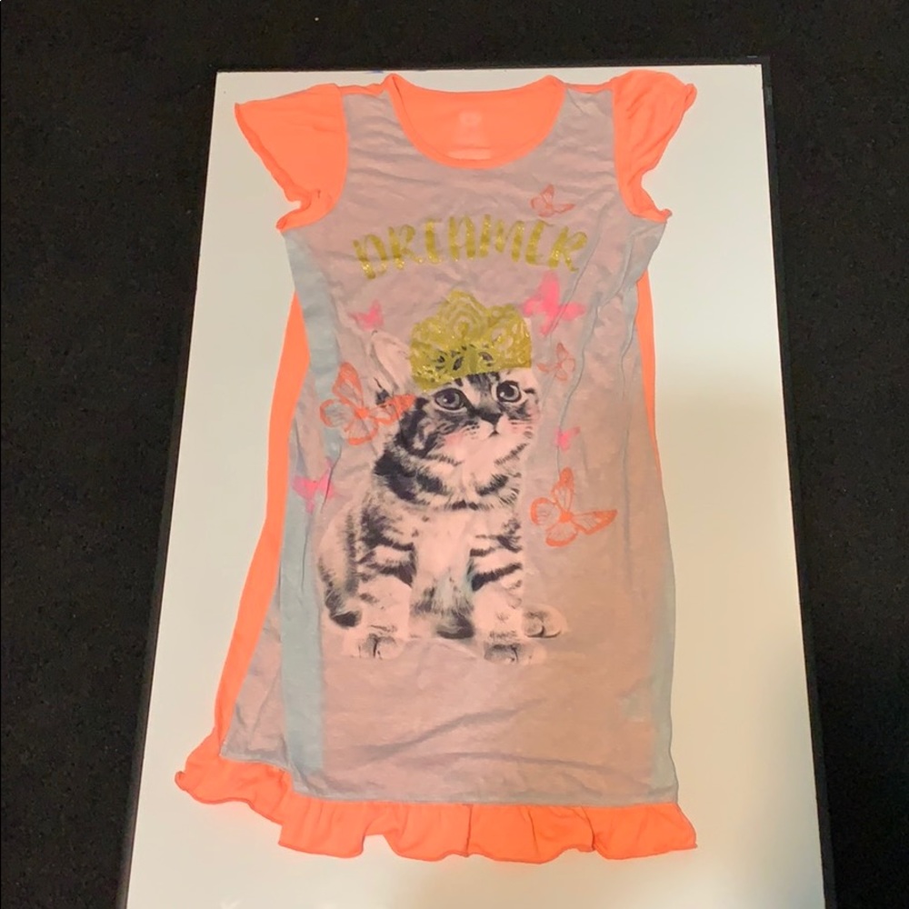 A girls night gown with a cat design on the front